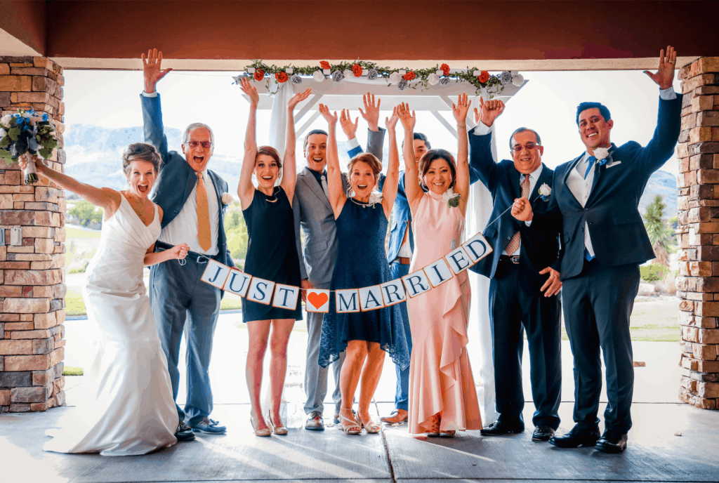 Small wedding in front of a just married sign