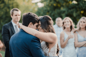 Wedding DJ plays first dance song for bride and groom