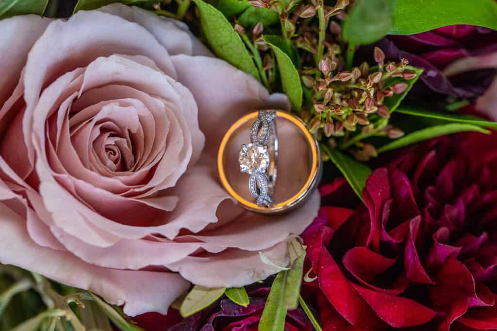 Wedding rings on pink roses.