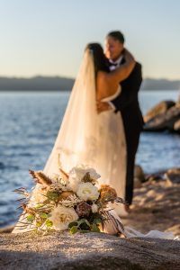 Brides at sunset in Lake Tahoe with the bouquet