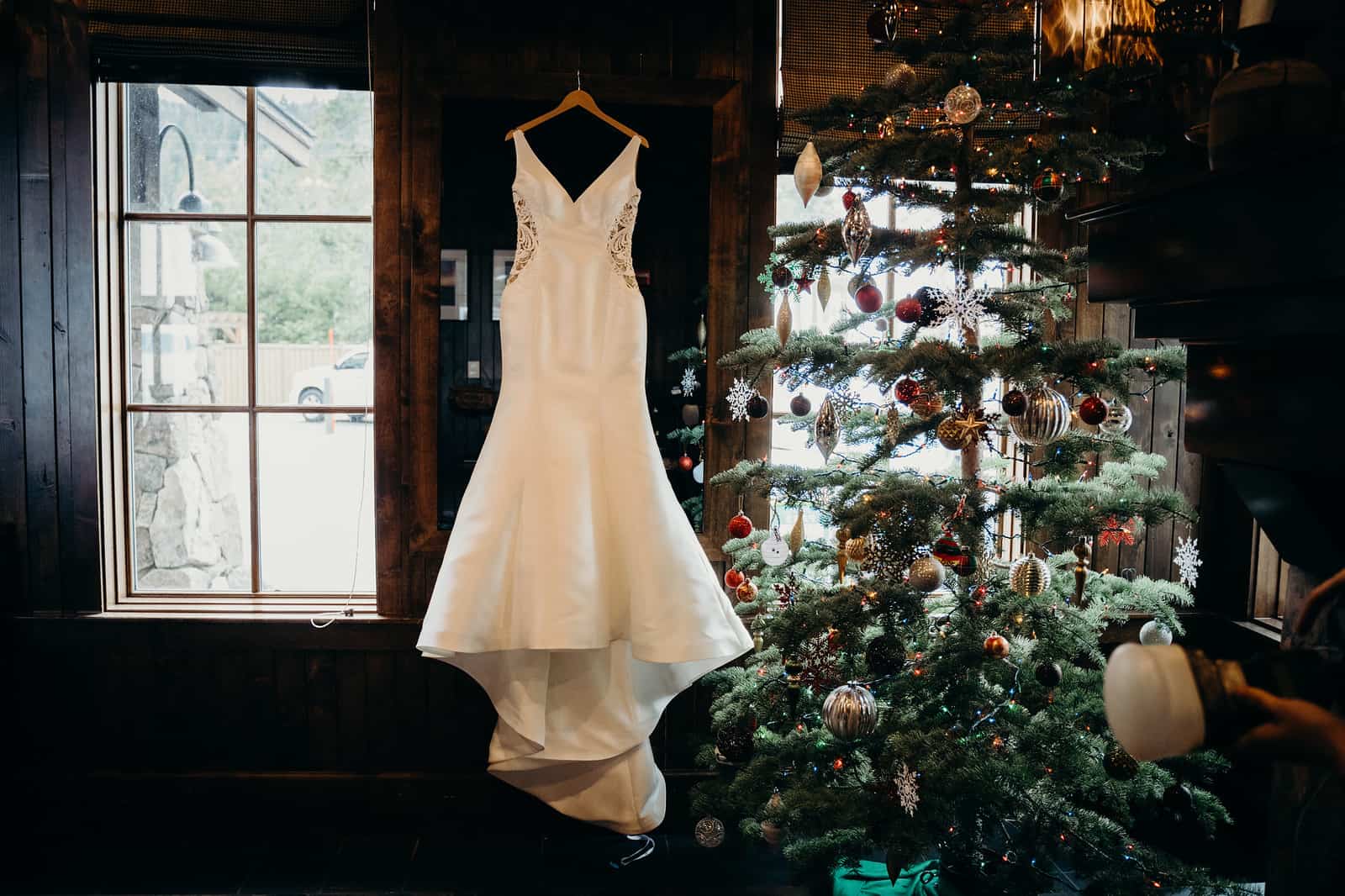 Wedding dress next to a christmas tree